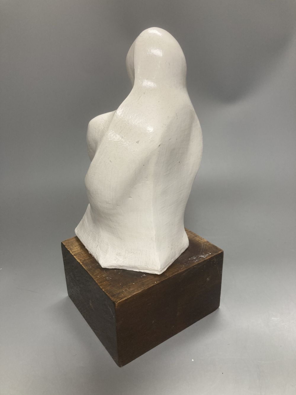 After Henry Moore, two related figural sculptures in wood and plaster, 31cm, white composition, 28cm
